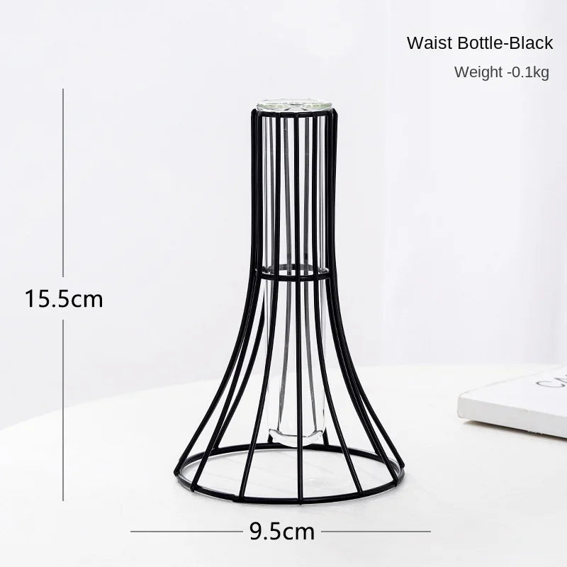 A black wrought iron waist bottle vase with a narrow neck and flared base, shown on a white surface.