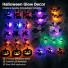 A collection of Halloween glow decor silhouettes including bats, spiders, and jack-o'-lanterns displayed on a dark background