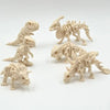 A set of three 3D printed dinosaur skeletons in a light beige color displayed against a white background.