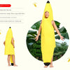 A child wearing a yellow banana suit costume standing outdoors.