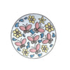 A white ceramic plate decorated with pink and yellow floral crystal designs.