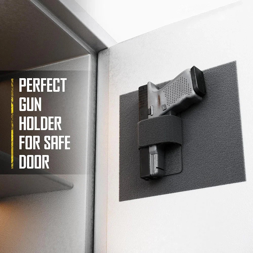 A black gun holder is mounted on a white wall, designed for a safe door.