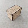 Antique carved wooden music box with intricate floral patterns on the lid and body