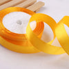Roll of gold yellow satin ribbon with white filler for crafts and gift wrapping