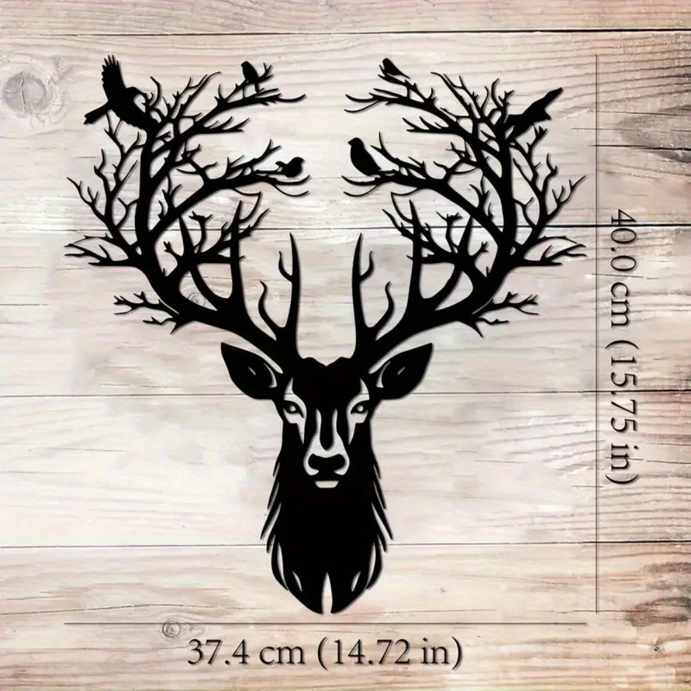 Black metal deer head wall sculpture with antlers and silhouette of birds on a wooden background.