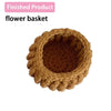 A finished, hand-crocheted flower basket made of brown yarn.