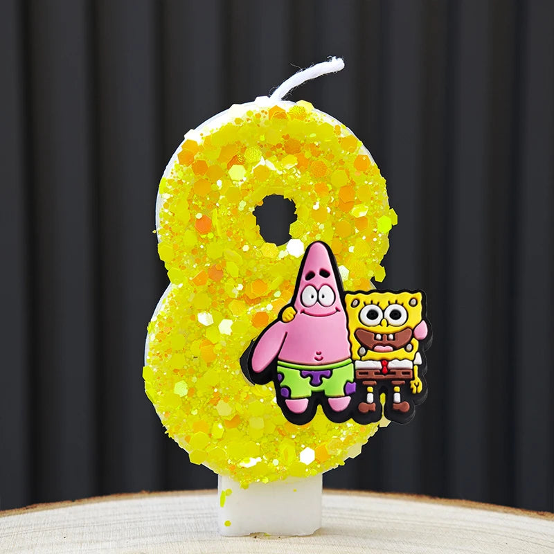 A yellow sponge cake candle shaped like the number 8 decorated with characters from SpongeBob Squarepants