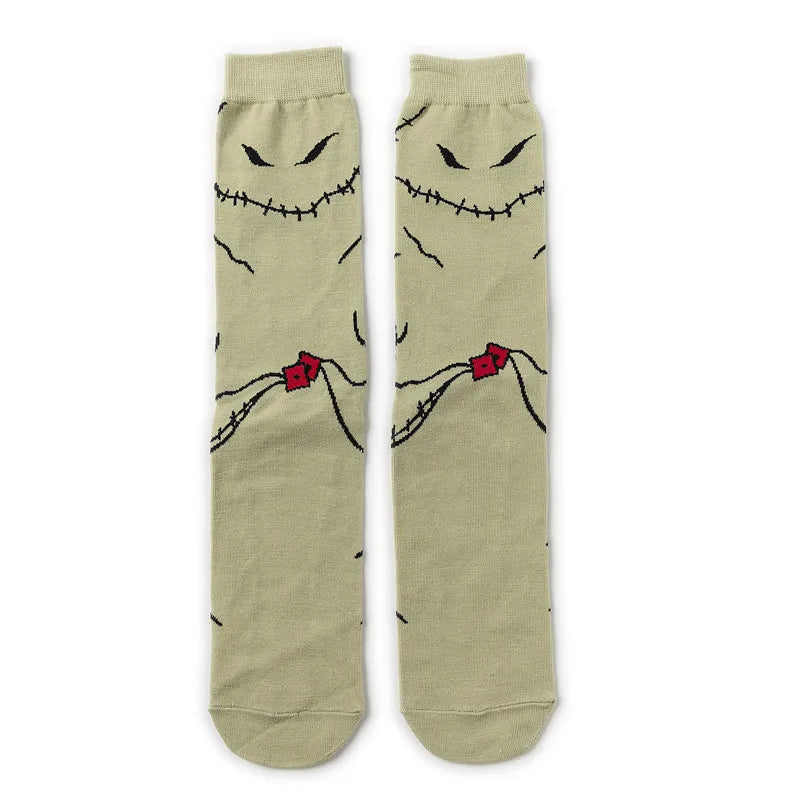 Pair of beige crew socks featuring black printed skulls and alien faces