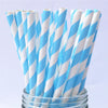 A bundle of white and light blue striped paper drinking straws in a glass container.