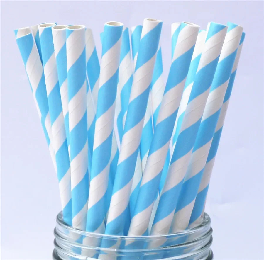 A bundle of white and light blue striped paper drinking straws in a glass container.