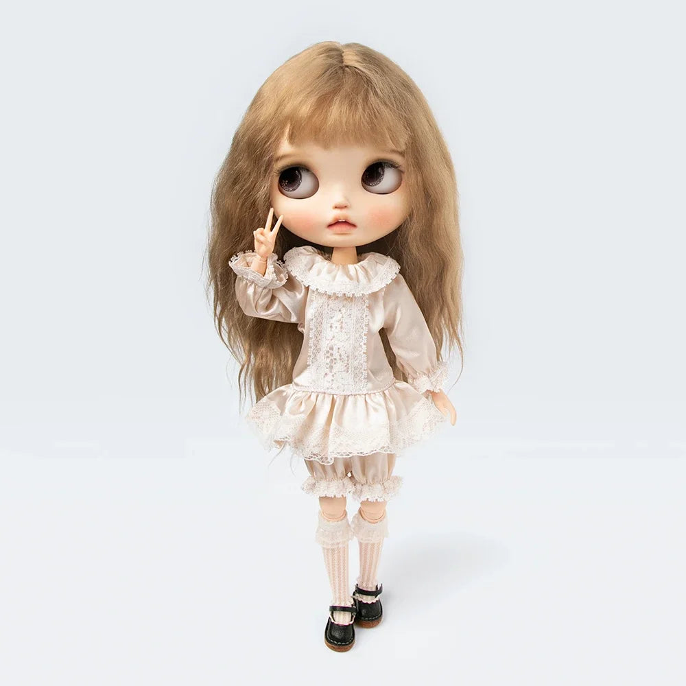 A vintage lace pajama set for a 1/6 doll featuring light pink fabric and delicate embroidery.