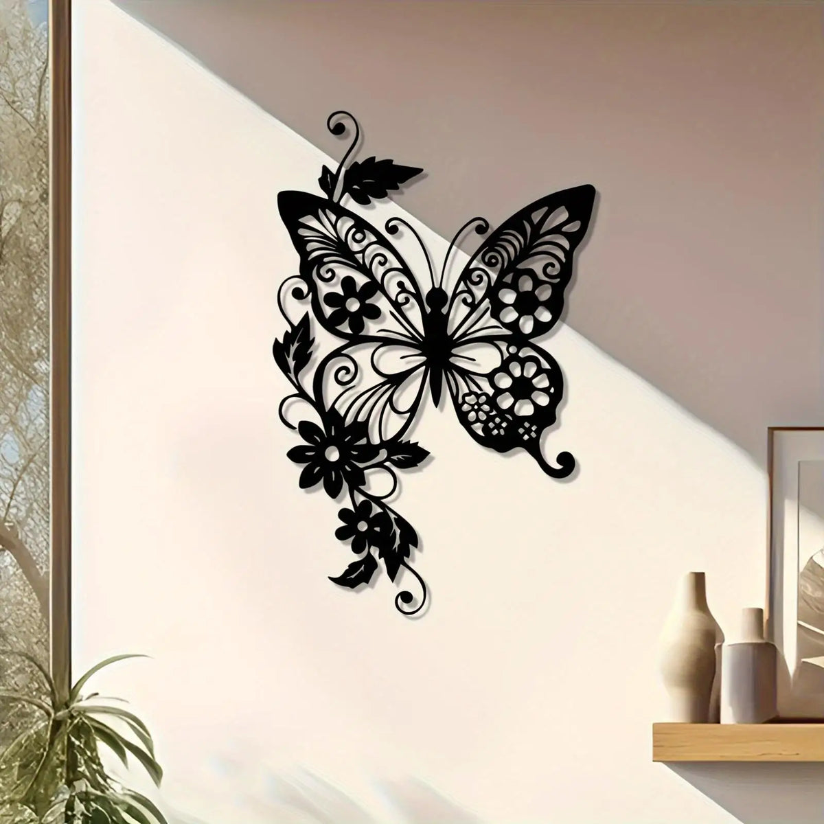 Black metal wall art featuring an elegant Art Nouveau butterfly design on a white wall.