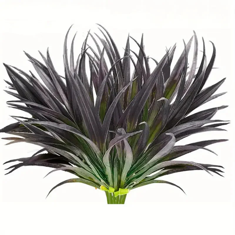 A cluster of dark purple and green artificial tall grass and tropical flowers for indoor or outdoor decor.