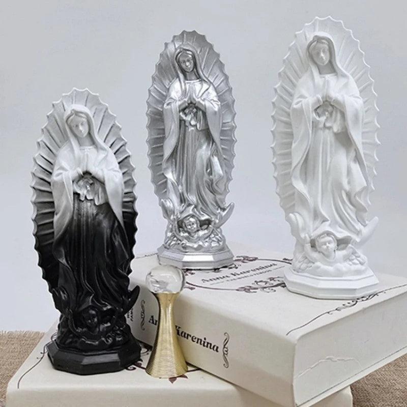 A set of three resin statues depicting Our Lady of Guadalupe in various finishes and poses.