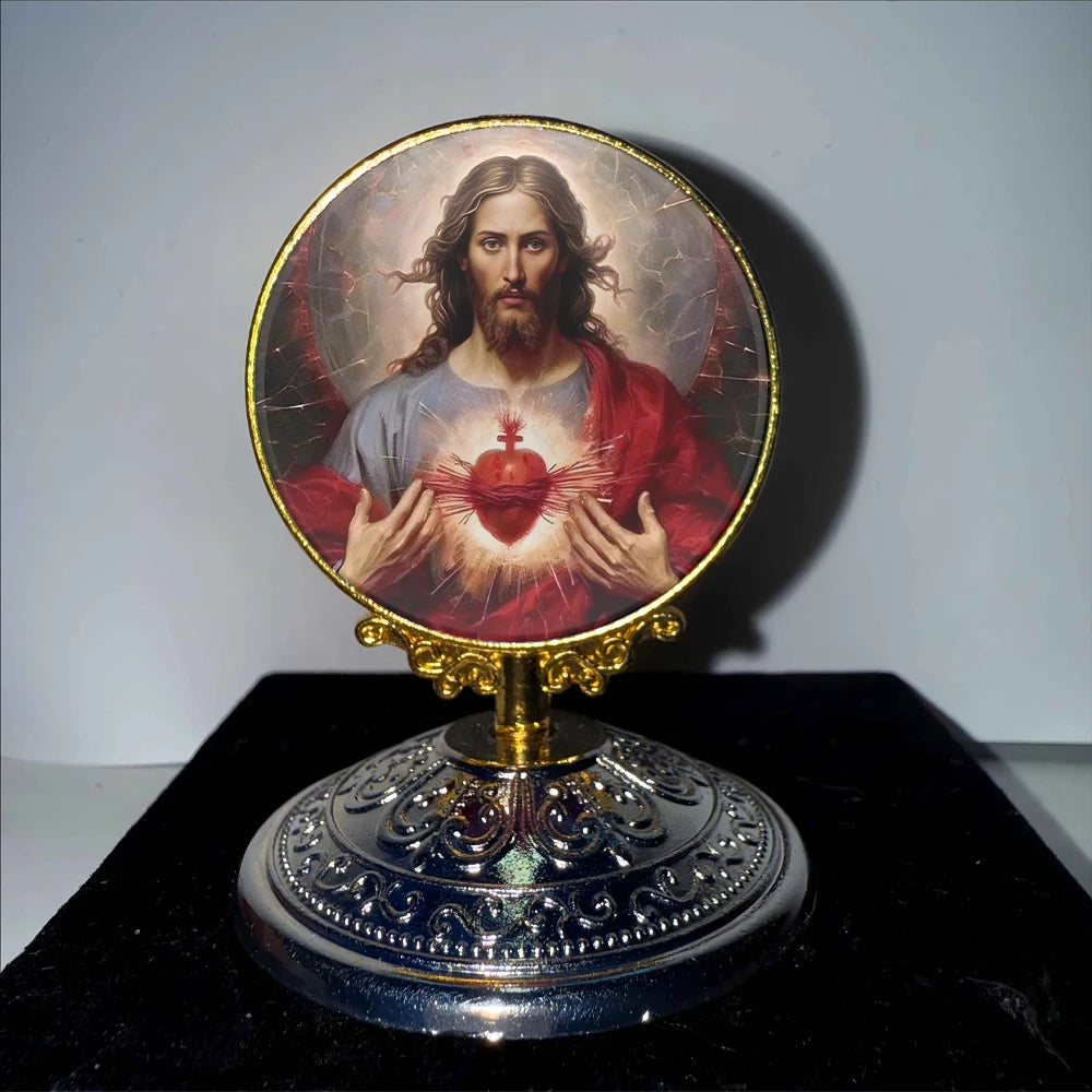 A round religious ornament featuring a depiction of Jesus with a glowing heart surrounded by light.