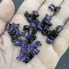 A handful of dark purple and black cat head glass beads for jewelry making