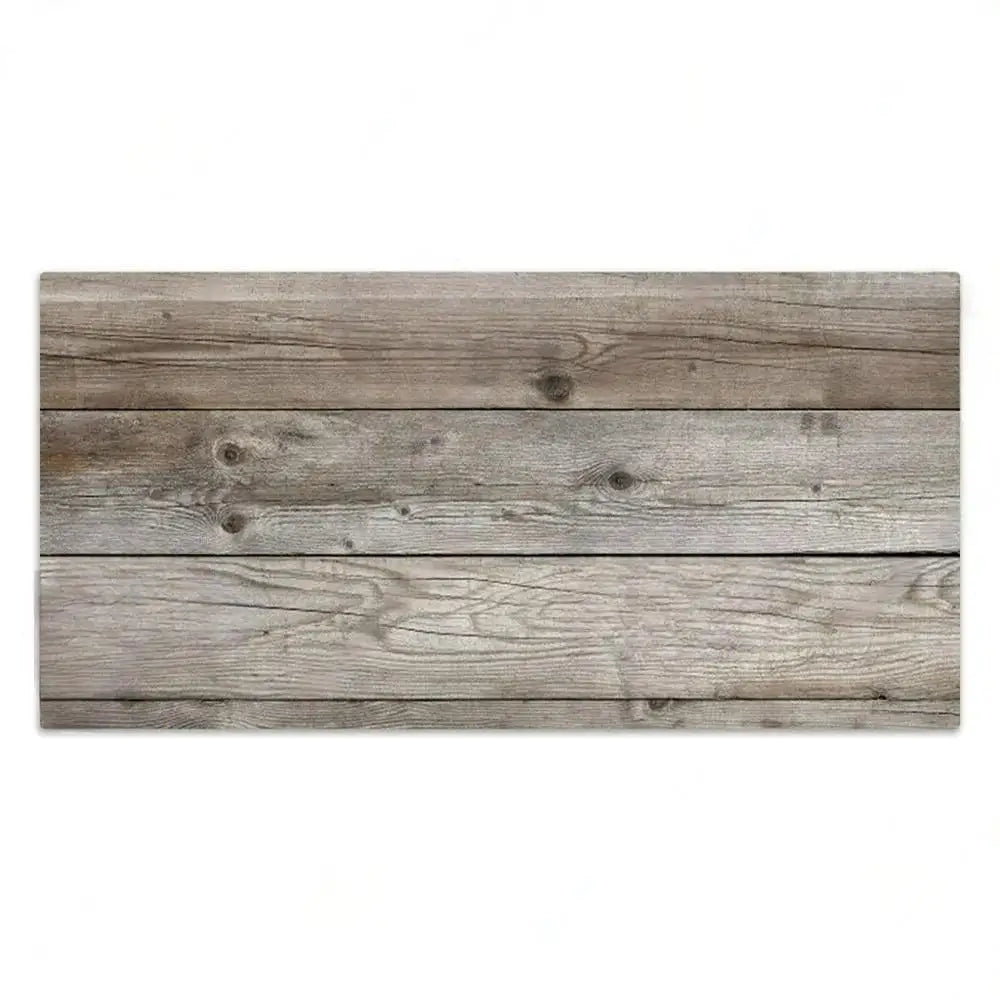 A horizontal wooden plank sign with weathered gray wood grain and visible knots.