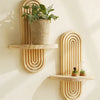 Geometric wooden wall shelves displaying a potted plant and a glass terrarium.