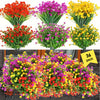 A large bouquet of artificial flowers in vibrant mixed colors including red, orange, yellow, and purple.