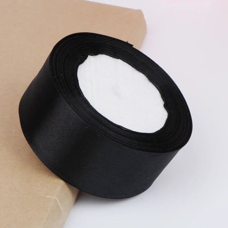 Roll of black satin ribbon for crafts and gift wrapping