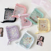 A collection of pink, purple, and green glitter star card binders for collectibles.