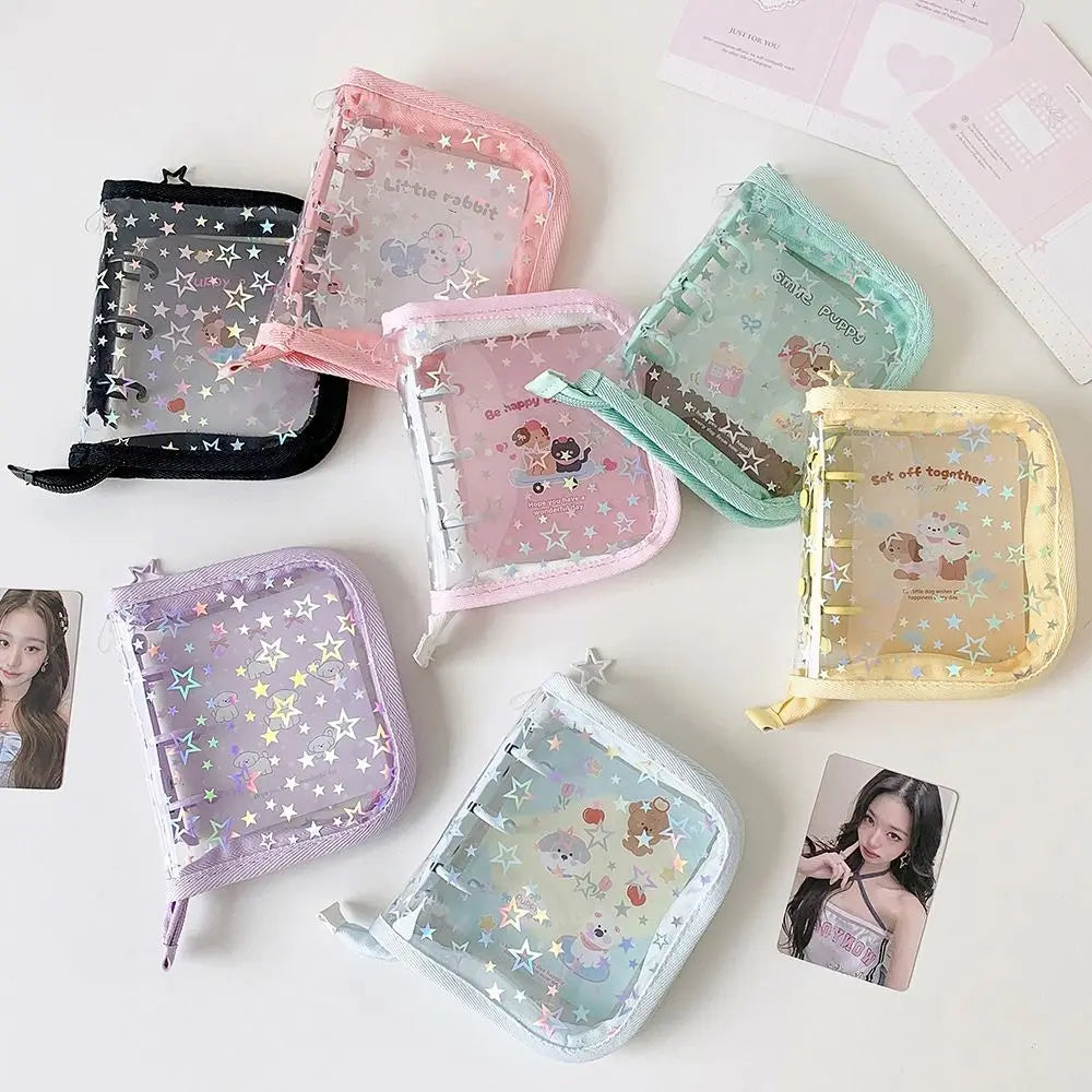 A collection of pink, purple, and green glitter star card binders for collectibles.