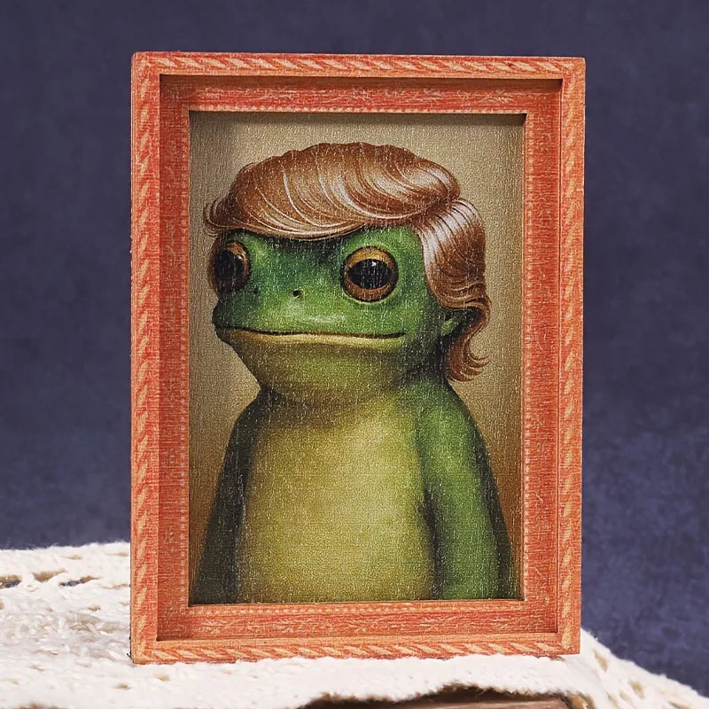 A cute green frog illustration framed in a wooden photo frame.