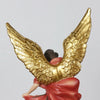 A resin statue of Saint Michael the Archangel with large golden wings and a red garment.