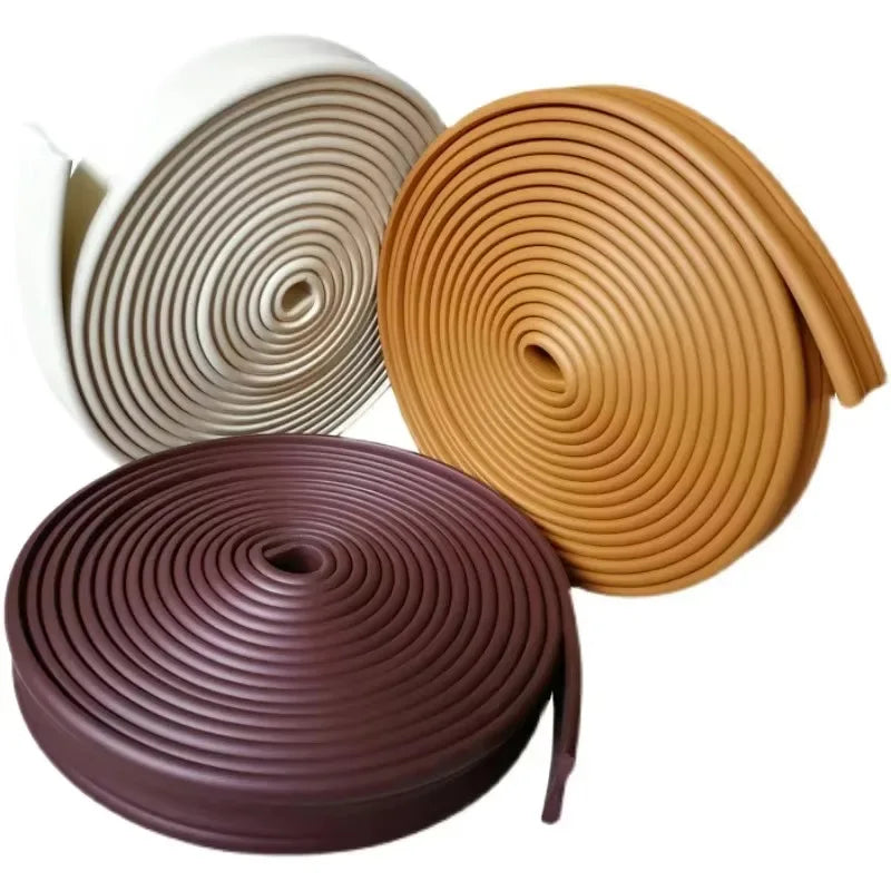 Rolls of self-adhesive flexible wall skirting strips in beige and brown colors.