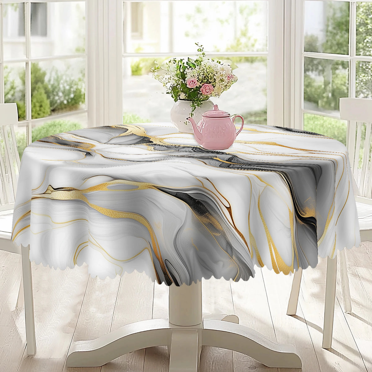 A white marble-printed tablecloth with gold and black ink textures is displayed on a table, featuring a pink teapot.