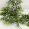 A branch of extra long pine vine used for holiday wreath decoration.