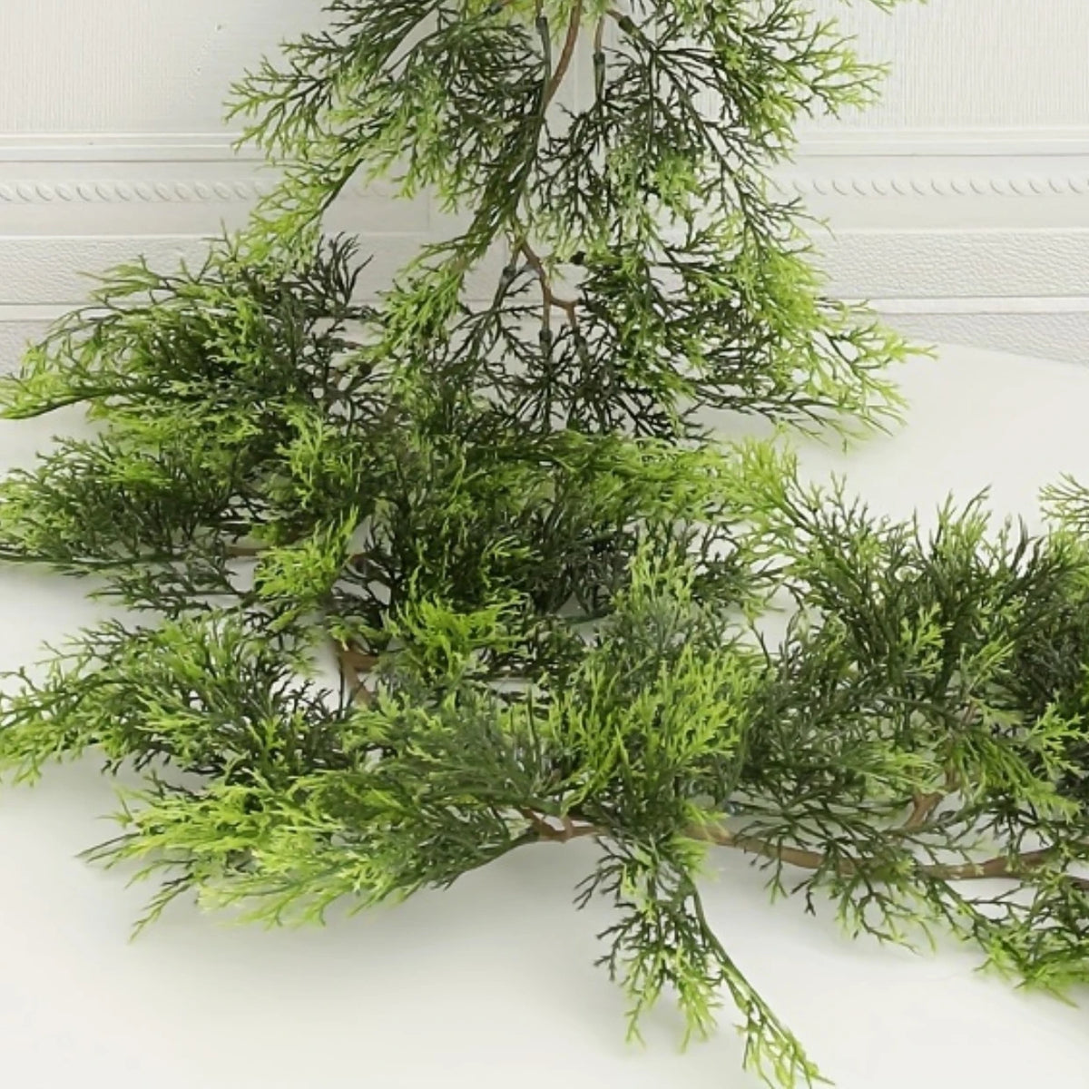 A branch of extra long pine vine used for holiday wreath decoration.