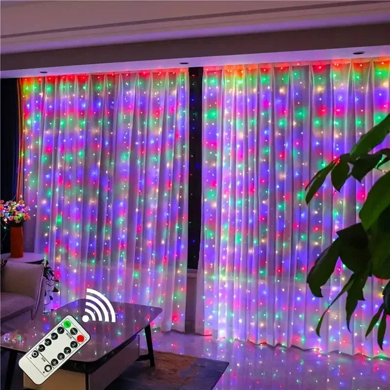A sheer white curtain illuminated by colorful fairy lights, with a remote control visible in the foreground.
