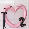 Pink heart-shaped balloon decoration with Happy Birthday text and a number 9