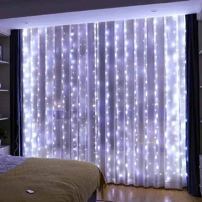 A sheer white curtain illuminated by vertical strings of twinkling blue fairy lights in a bedroom setting.