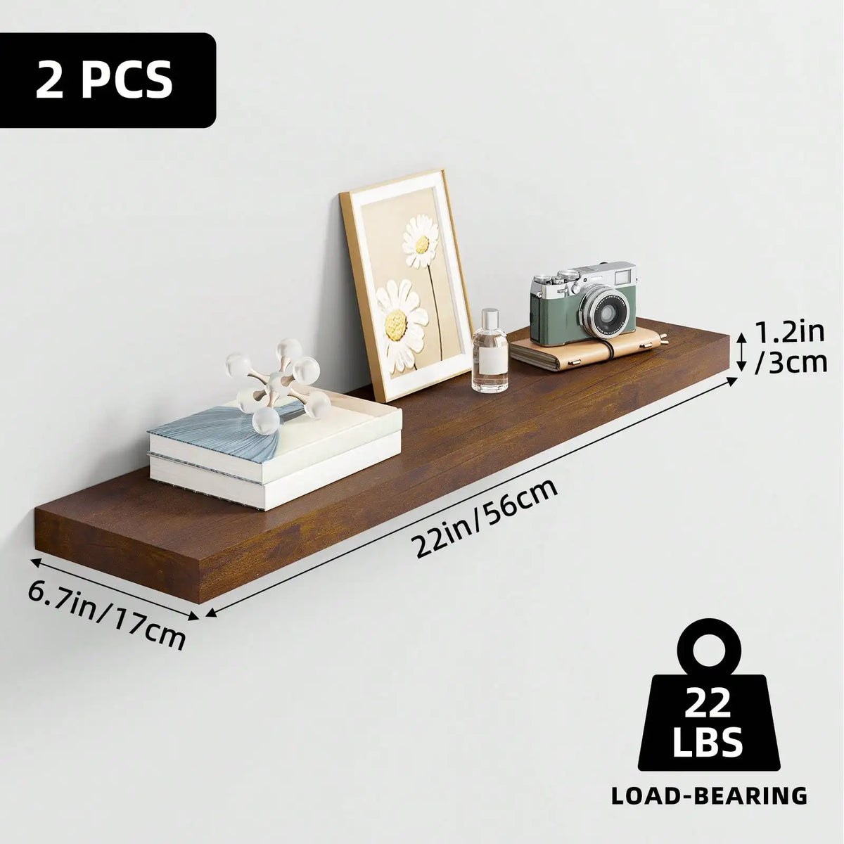 A set of two wooden floating shelves mounted on a wall, featuring a framed flower and small decorative items.