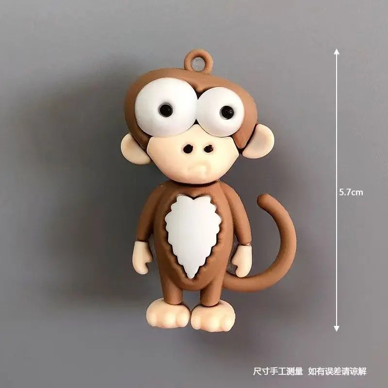 A small, round brown cartoon animal figure with large white eyes and a heart shape on its chest.