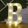 A glowing warm white LED alphabet letter light shaped like the letter B, illuminating the text on a wooden surface.