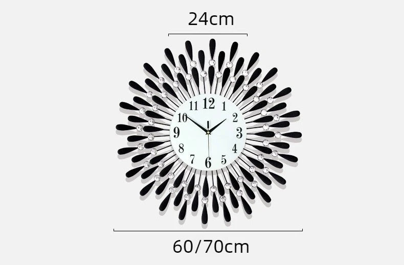 A modern minimalist metal wall clock with a black and silver sunburst design.