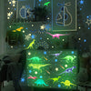 A display of glow-in-the-dark dinosaur stickers on a green wall, featuring various dinosaur silhouettes and plants.