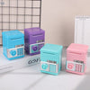 A collection of colorful kids mini piggy banks and money boxes in blue, purple, and pink on a white surface.