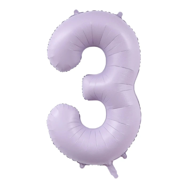 A purple foil number balloon shaped like the number three.