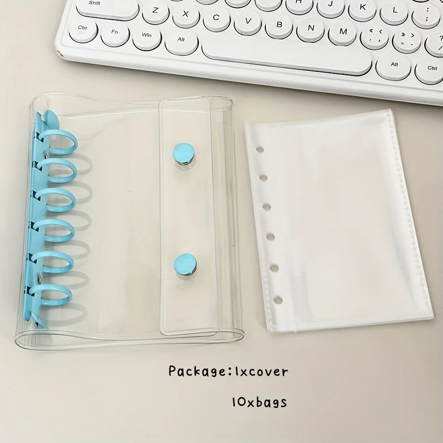 A clear plastic binder cover and a white sheet protector are shown next to a computer keyboard.