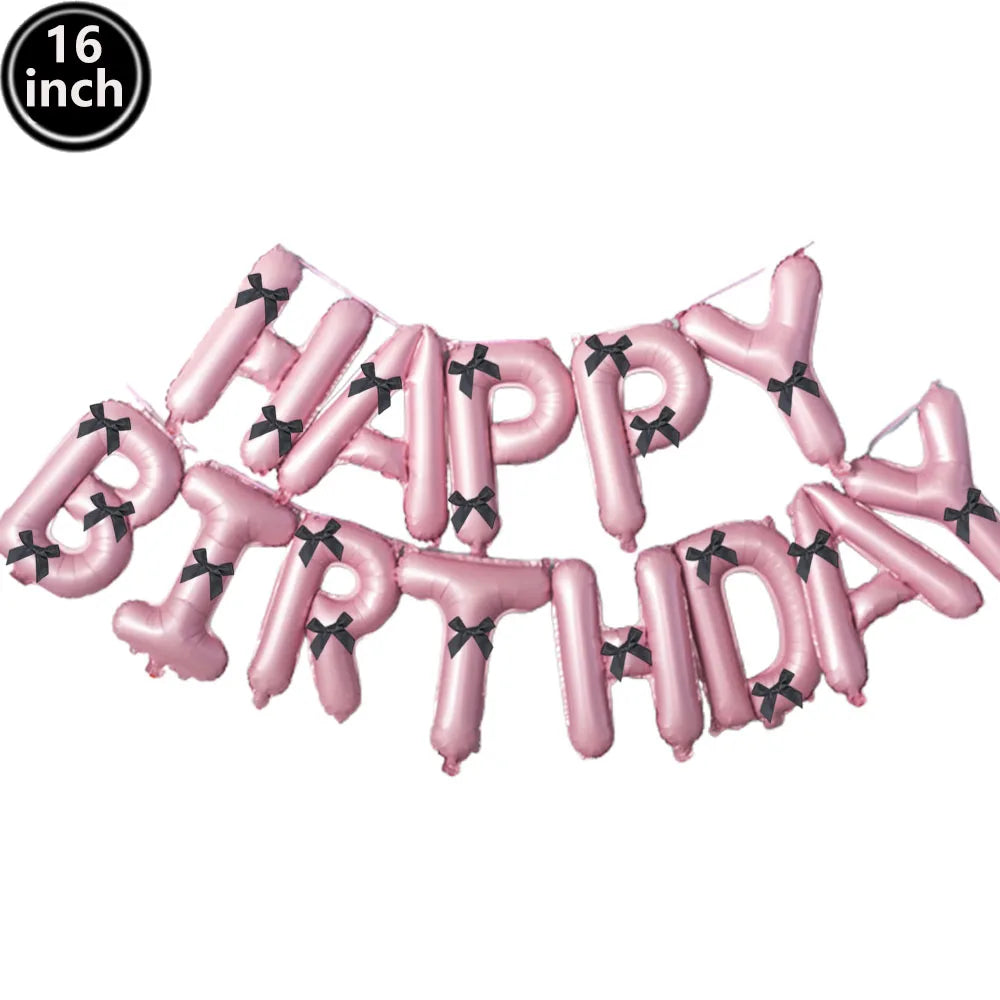 A set of pink foil letter balloons spelling out HAPPY BIRTHDAY for a party decoration.
