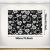 A rectangular photo backdrop featuring a pattern of glittering heart shapes on a dark background.