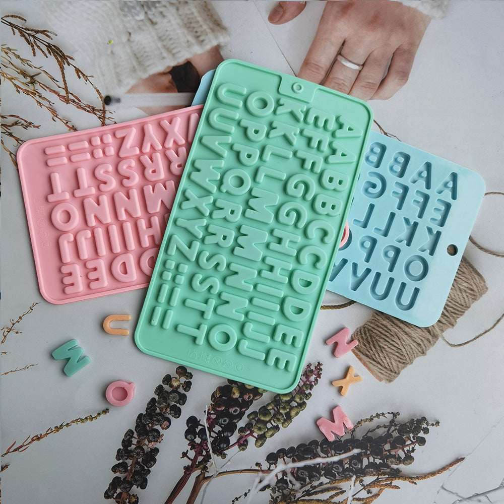 A set of pastel silicone molds shaped like letters and numbers for baking