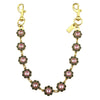 Gold chain bag strap with pink and black floral charms and a clasp.