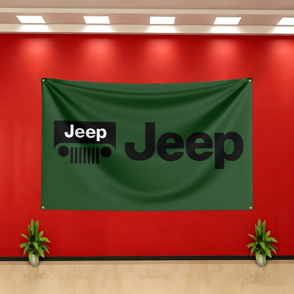 A dark green Jeep banner hangs on a red wall with white ceiling lights and potted plants below.