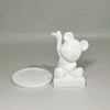A white bear-shaped jewelry and accessory tray with a small ceramic bear figure.