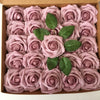 A box filled with artificial real touch foam roses in various shades of pink and mauve.